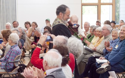 Rev. Barnaby dedicating a baby